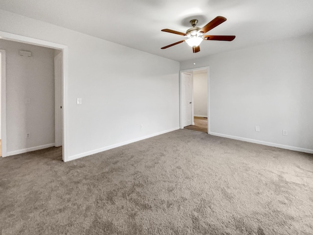 carpeted empty room featuring ceiling fan