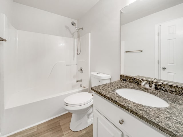 full bathroom featuring toilet, vanity, and shower / bathtub combination