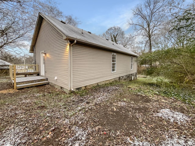 view of side of home with a wooden deck