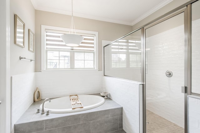 bathroom with ornamental molding and shower with separate bathtub