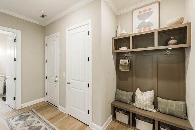 mudroom with crown molding and hardwood / wood-style floors