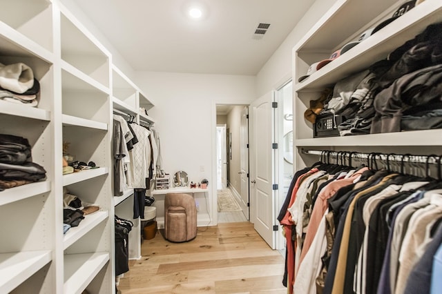 walk in closet featuring light hardwood / wood-style flooring