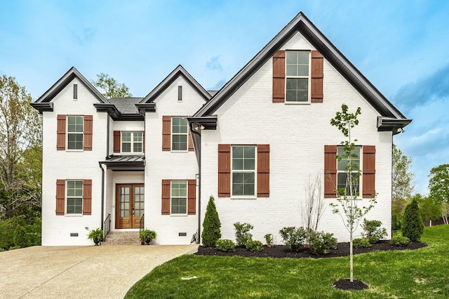 view of front of house with a front yard and french doors