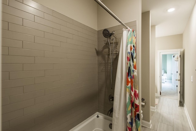 bathroom with shower / bath combo with shower curtain