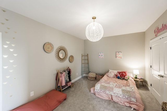 bedroom with light colored carpet and a notable chandelier