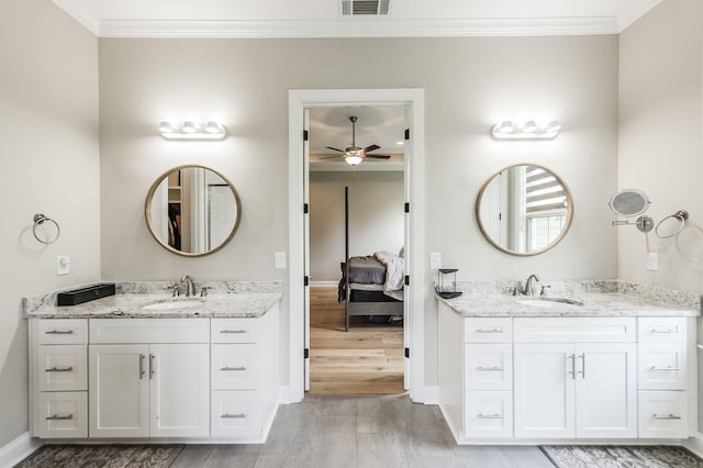 bathroom with ceiling fan, ornamental molding, wood-type flooring, and vanity