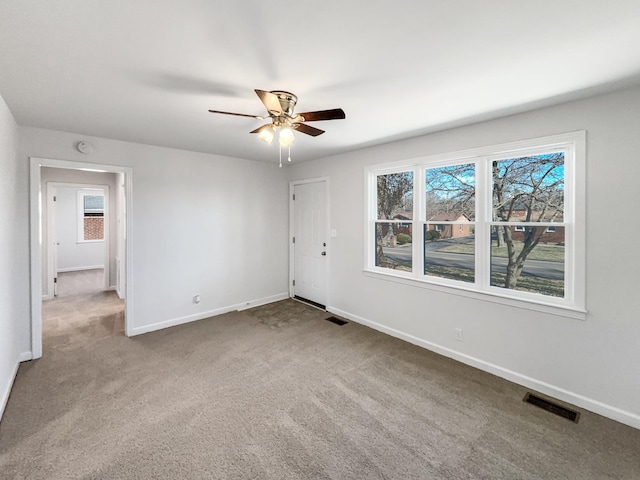 carpeted empty room featuring ceiling fan