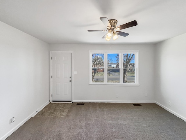 empty room featuring ceiling fan and carpet floors