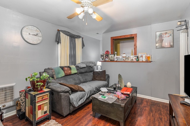 living room featuring heating unit, dark hardwood / wood-style flooring, and ceiling fan