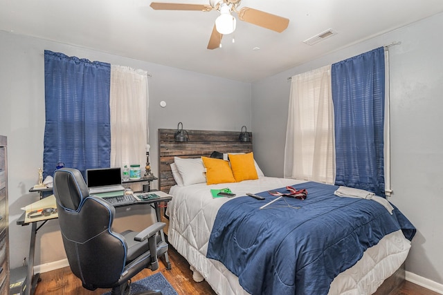 bedroom with dark wood-type flooring and ceiling fan