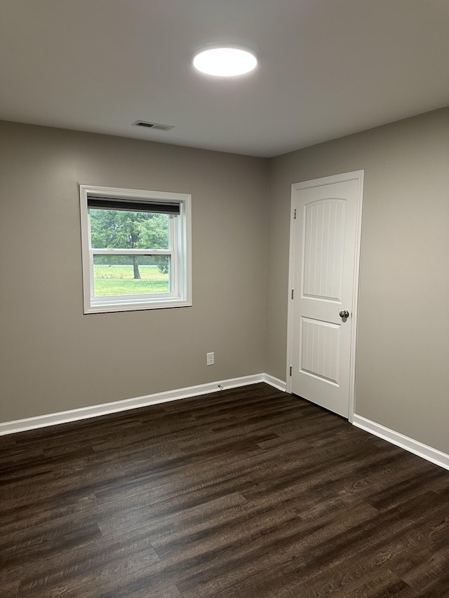 unfurnished room with dark hardwood / wood-style floors