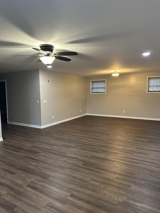 empty room with ceiling fan and dark wood-type flooring