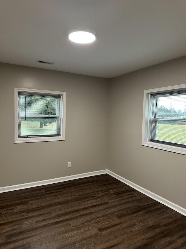 spare room featuring dark hardwood / wood-style flooring