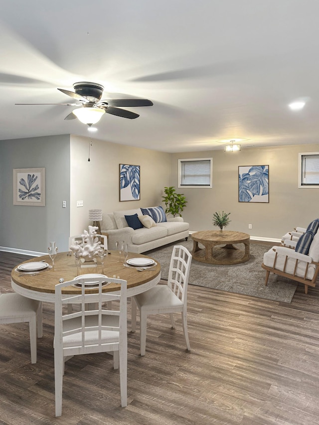 dining area with hardwood / wood-style floors and ceiling fan