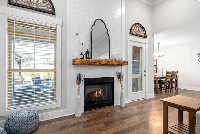 living room with an inviting chandelier and dark hardwood / wood-style flooring