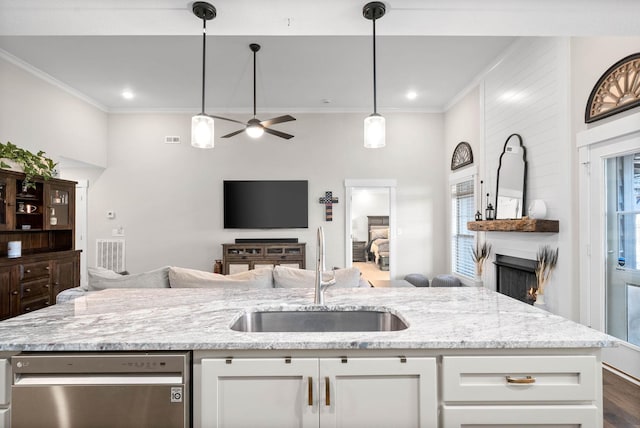 kitchen with sink, white cabinets, stainless steel dishwasher, and light stone countertops