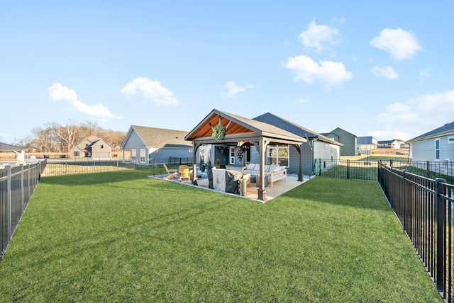 rear view of property with an outdoor living space, a patio area, a gazebo, and a lawn