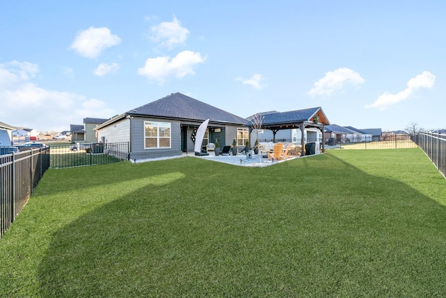 rear view of house featuring a patio area, a gazebo, and a yard