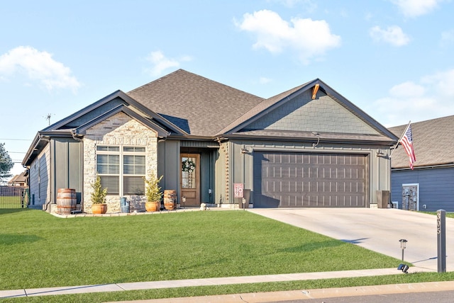 craftsman-style house with a garage and a front lawn