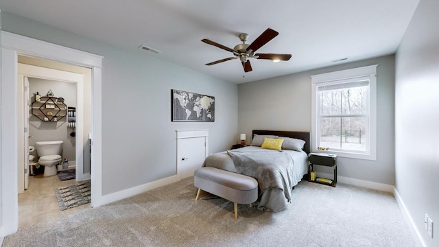 carpeted bedroom with connected bathroom and ceiling fan