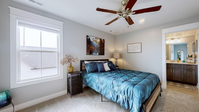 carpeted bedroom featuring connected bathroom and ceiling fan