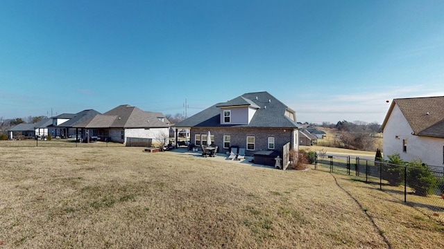 rear view of house with a yard and a patio area