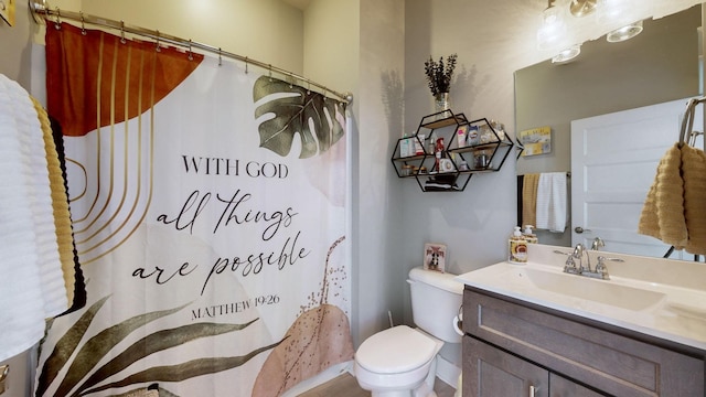 bathroom featuring vanity, toilet, and curtained shower