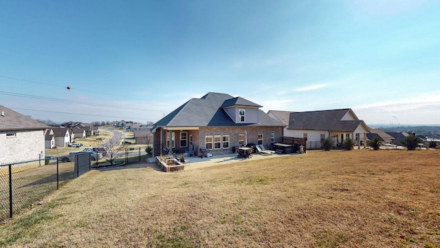 rear view of property with a patio and a yard