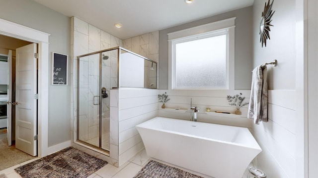 bathroom featuring separate shower and tub