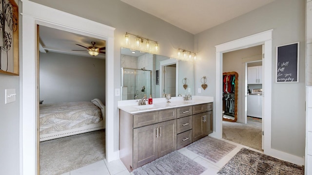 bathroom featuring walk in shower, tile patterned floors, washer / dryer, vanity, and ceiling fan