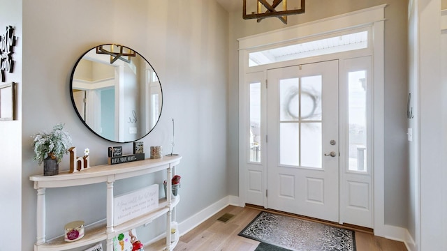 entrance foyer with light hardwood / wood-style flooring and a healthy amount of sunlight