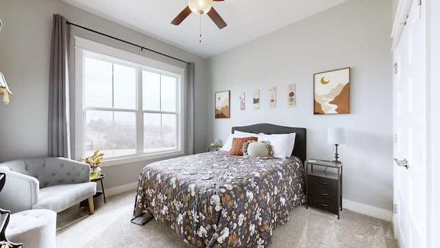 bedroom with multiple windows, light carpet, and ceiling fan