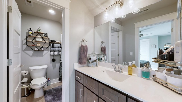 bathroom with vanity, toilet, and hardwood / wood-style floors