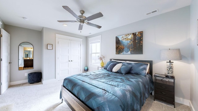 carpeted bedroom featuring ceiling fan and a closet