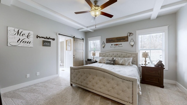 carpeted bedroom with beam ceiling, a barn door, coffered ceiling, and ceiling fan