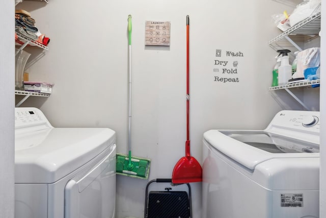 clothes washing area with washing machine and clothes dryer