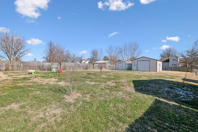 view of yard featuring a storage shed and a garage