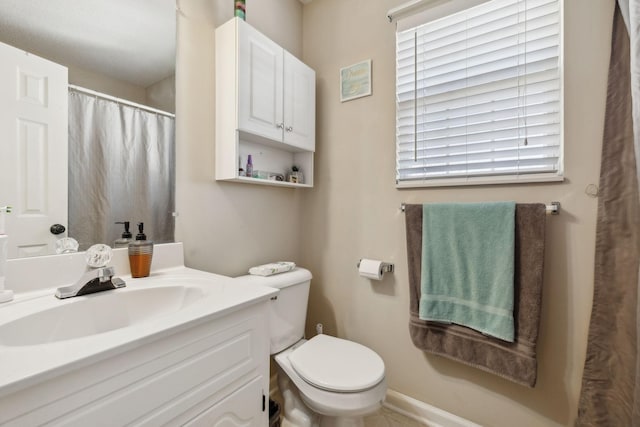 bathroom with toilet and vanity