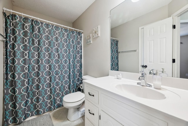 bathroom with a textured ceiling, toilet, and vanity