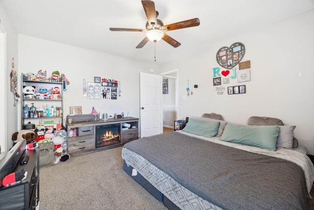 bedroom with ceiling fan and carpet floors