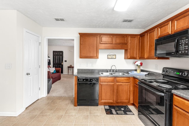 kitchen featuring a textured ceiling, sink, and black appliances