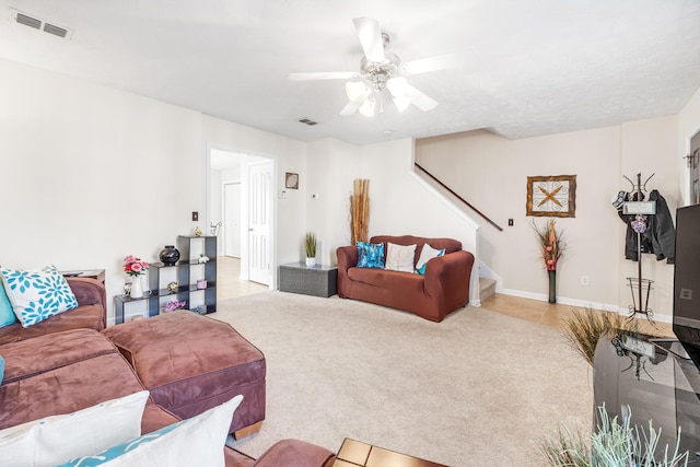 carpeted living room featuring ceiling fan