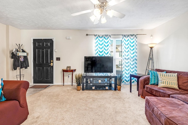 living room featuring carpet floors, a textured ceiling, and ceiling fan