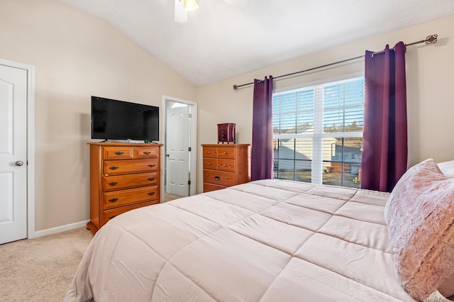 carpeted bedroom with ceiling fan and lofted ceiling