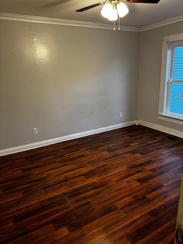 unfurnished room featuring ceiling fan, dark wood-type flooring, and ornamental molding