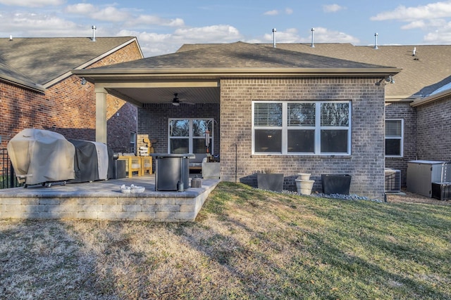 back of property featuring a patio area, a yard, and ceiling fan