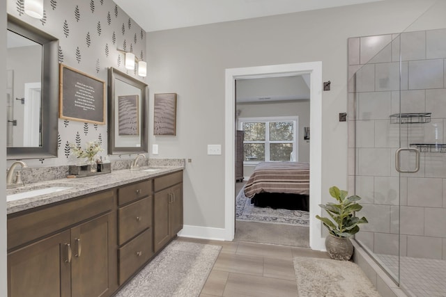 bathroom with a shower with shower door and vanity