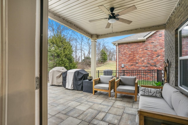 view of patio with fence, a ceiling fan, and area for grilling