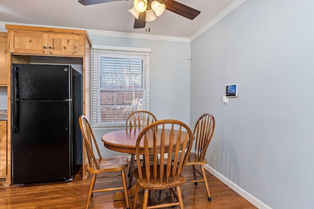 dining area featuring ceiling fan, crown molding, and hardwood / wood-style floors