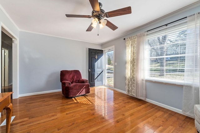 sitting room featuring ceiling fan, crown molding, and hardwood / wood-style floors